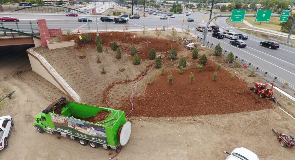 cascade mulch blown into multiple beds along highway slopes