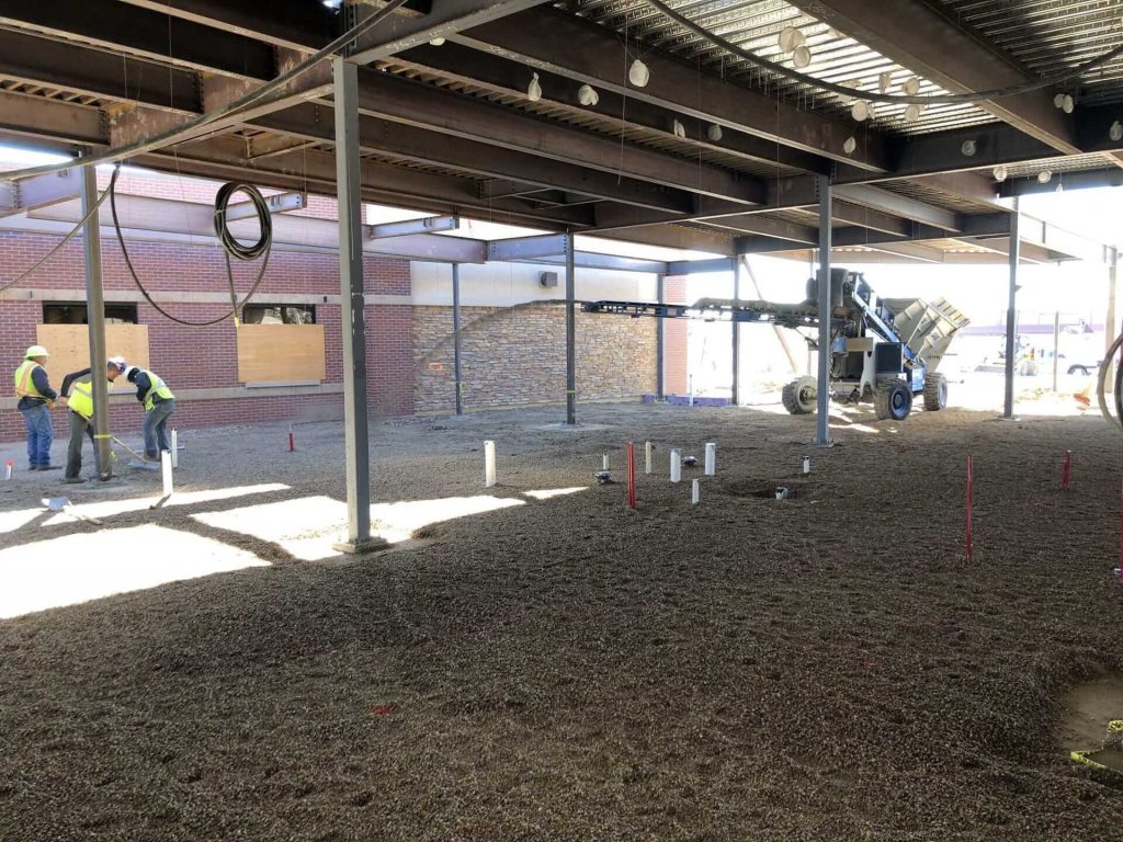 All terrain slinger placing gravel in a building in Loveland CO