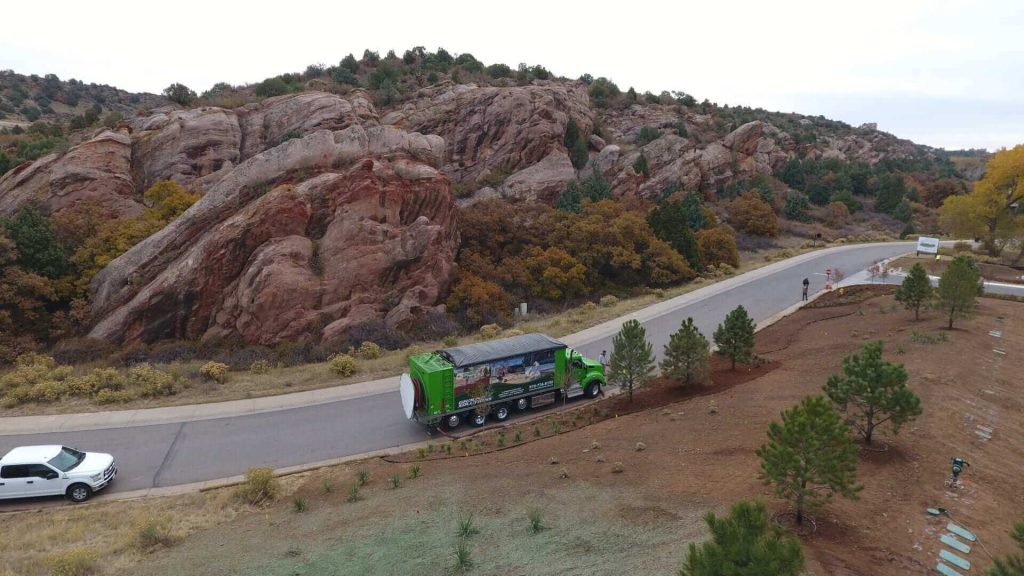 Ground Solutions blower trucks placing cascade cedar mulch at a clubhouse and fitness center facility at a Golf Club in Colorado