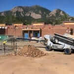 Slinger Truck placing crushed aggregate for drainage in playground areas in Colorado