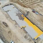 Bedrock's on-site slinger (OS7) placed crushed aggregate for backfill around StormTech system