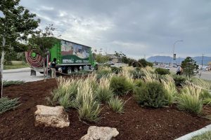 Ground Solutions blower truck team performing high-volume mulch installation and professional site cleanup at a commercial development.