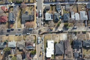 Aerial view of a Ground Solutions hydrovac excavation team performing precise utility daylighting and slot trenching in a tight residential neighborhood in Colorado.
