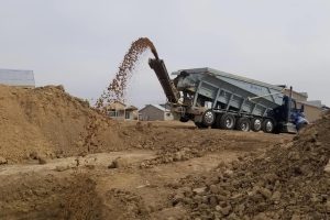 Material placement via slinger truck.