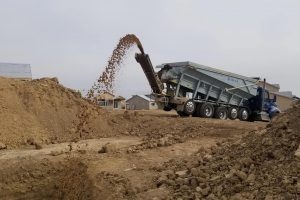 Material placement via slinger truck.